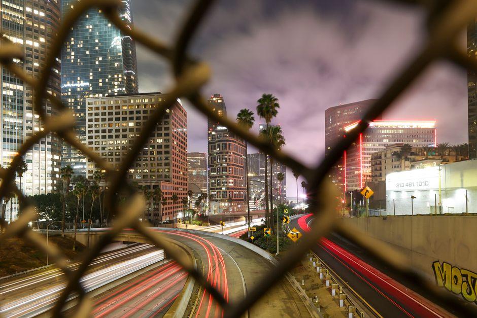 Vibrant Los Angeles Cityscape Through Fenced View